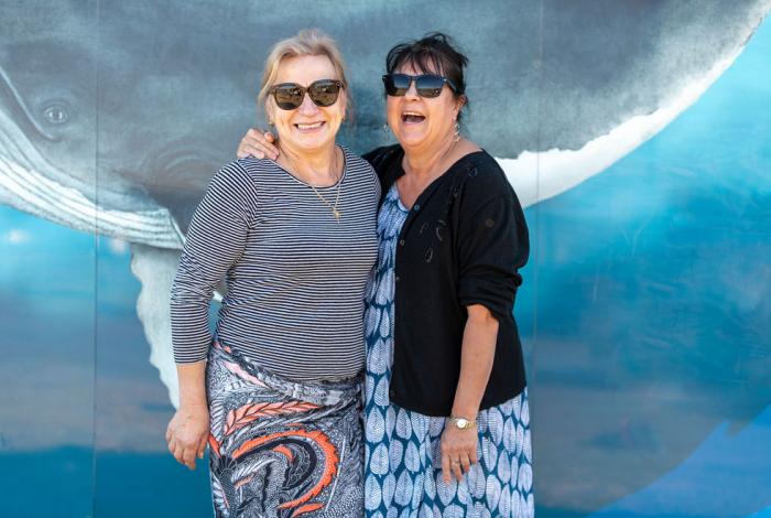 Photo of two seniors in front of artwork