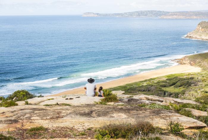 Two people looking out at the ocean