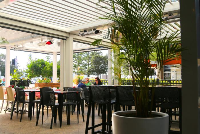 Photo of patrons seated in an outdoor dining setting